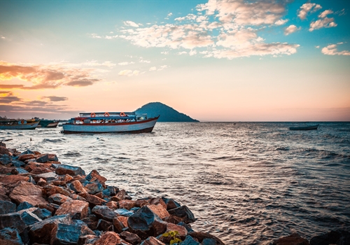 A boat trip in Malawi showing a small boat close to the shore.